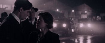 Movie still from “Woman in Gold” (2015), directed by Simon Curtis – A man and a woman standing next to each other in the dark; Medium shot, Over the shoulder angle