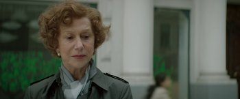 Movie still from “Woman in Gold” (2015), directed by Simon Curtis – An older woman is looking at something in the distance; Close Up shot, Over the shoulder angle