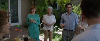 Movie still from “Woman in Gold” (2015), directed by Simon Curtis – A group of people standing next to each other on a patio; Medium shot, Over the shoulder angle