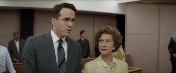 Movie still from “Woman in Gold” (2015), directed by Simon Curtis – A man and a woman standing next to each other in a courtroom; Close Up shot, Over the shoulder angle