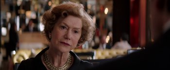 Movie still from “Woman in Gold” (2015), directed by Simon Curtis – An older woman in a black dress and a gold necklace; Close Up shot, Over the shoulder angle