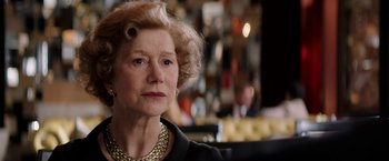Movie still from “Woman in Gold” (2015), directed by Simon Curtis – An older woman wearing a necklace and a black jacket; Close Up shot, Over the shoulder angle