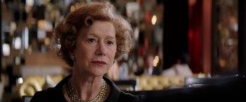 Movie still from “Woman in Gold” (2015), directed by Simon Curtis – An older woman wearing a black jacket and a gold necklace; Close Up shot, Over the shoulder angle
