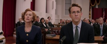 Movie still from “Woman in Gold” (2015), directed by Simon Curtis – A group of people sitting in a court room with microphones; Close Up shot, Over the shoulder angle