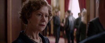 Movie still from “Woman in Gold” (2015), directed by Simon Curtis – An older woman in a black suit and pearls; Close Up shot, Over the shoulder angle
