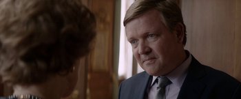 Movie still from “Woman in Gold” (2015), directed by Simon Curtis – A person wearing a suit and tie; Close Up shot, Over the shoulder angle