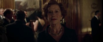 Movie still from “Woman in Gold” (2015), directed by Simon Curtis – An older woman wearing a black dress and a necklace; Close Up shot, Over the shoulder angle