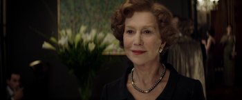 Movie still from “Woman in Gold” (2015), directed by Simon Curtis – An older woman wearing a necklace and a black dress; Close Up shot, Over the shoulder angle
