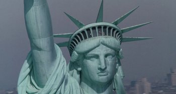 Movie still from “Working Girl” (1988), directed by Mike Nichols – The statue of liberty is seen in this image; Extreme Wide shot, Low angle