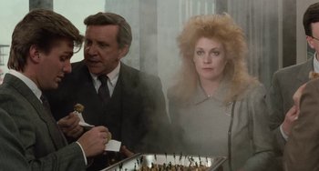 Movie still from “Working Girl” (1988), directed by Mike Nichols – A man and a woman are eating food; Medium shot, Over the shoulder angle