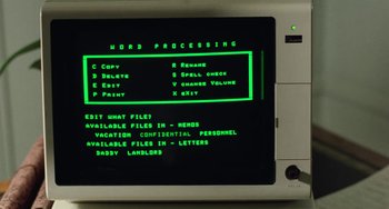 Movie still from “Working Girl” (1988), directed by Mike Nichols – A computer screen with instructions on how to use the computer; Extreme Close Up shot, High angle
