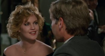 Movie still from “Working Girl” (1988), directed by Mike Nichols – A man and a woman talking to each other; Close Up shot, Over the shoulder angle