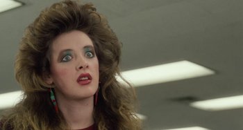 Movie still from “Working Girl” (1988), directed by Mike Nichols – A person with long curly hair; Close Up shot, Low angle