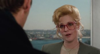 Movie still from “Working Girl” (1988), directed by Mike Nichols – A woman wearing glasses talking to a man in front of a body of water; Close Up shot, Over the shoulder angle