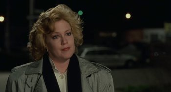 Movie still from “Working Girl” (1988), directed by Mike Nichols – A person outside at night; Close Up shot, Over the shoulder angle