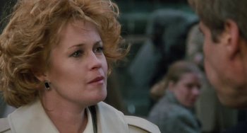 Movie still from “Working Girl” (1988), directed by Mike Nichols – A person with curly red hair; Close Up shot, Over the shoulder angle