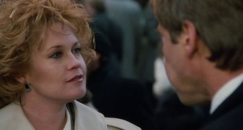 Movie still from “Working Girl” (1988), directed by Mike Nichols – A woman with red hair is talking to a man; Close Up shot, Over the shoulder angle