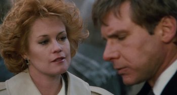 Movie still from “Working Girl” (1988), directed by Mike Nichols – A man and a woman looking at one another; Close Up shot, Over the shoulder angle