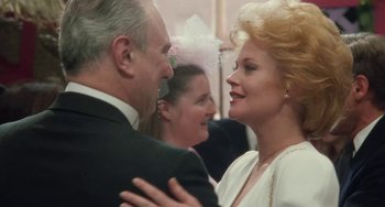 Movie still from “Working Girl” (1988), directed by Mike Nichols – A man and a woman are smiling at each other; Close Up shot, Over the shoulder angle