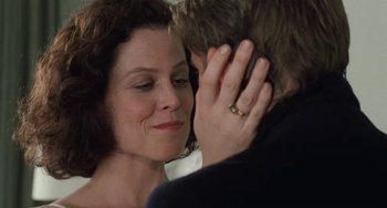 Movie still from “Working Girl” (1988), directed by Mike Nichols – A man and a woman kissing in front of a bathroom mirror; Close Up shot, Over the shoulder angle