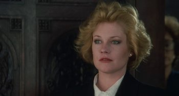 Movie still from “Working Girl” (1988), directed by Mike Nichols – A person wearing a suit and tie; Close Up shot, Low angle