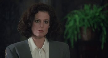 Movie still from “Working Girl” (1988), directed by Mike Nichols – A person wearing a suit and tie; Close Up shot, Low angle