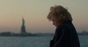 Movie still from “Working Girl” (1988), directed by Mike Nichols – A woman standing in front of the statue of liberty; Medium shot, Low angle