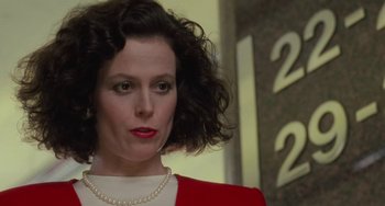 Movie still from “Working Girl” (1988), directed by Mike Nichols – A person wearing a necklace; Close Up shot, Low angle