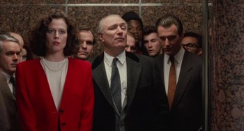 Movie still from “Working Girl” (1988), directed by Mike Nichols – A group of men and women standing next to each other; Medium shot, Low angle