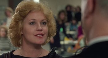 Movie still from “Working Girl” (1988), directed by Mike Nichols – A person wearing a black shirt; Close Up shot, Over the shoulder angle