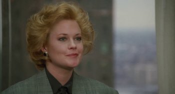 Movie still from “Working Girl” (1988), directed by Mike Nichols – A woman with blonde hair wearing a suit and tie; Close Up shot, Low angle
