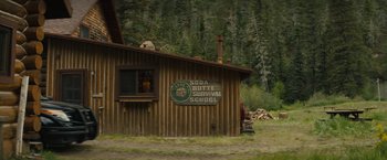 Movie still from “Wrong Turn” (2021), directed by Mike P. Nelson – A building with a sign on the side of it; Extreme Wide shot, High angle