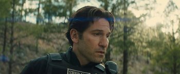 Movie still from “Wrong Turn” (2021), directed by Mike P. Nelson – A person with a microphone; Close Up shot, Over the shoulder angle