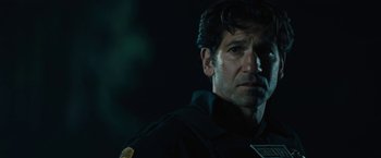 Movie still from “Wrong Turn” (2021), directed by Mike P. Nelson – A person wearing a black shirt; Close Up shot, Low angle