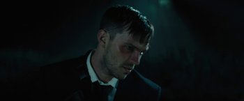 Movie still from “Wrong Turn” (2021), directed by Mike P. Nelson – A person wearing a suit and tie; Close Up shot, Low angle