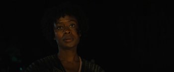 Movie still from “Wrong Turn” (2021), directed by Mike P. Nelson – A black woman with dark hair is looking up; Close Up shot, Low angle