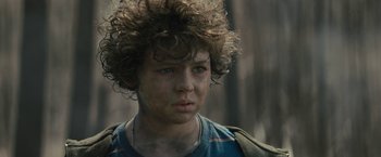 Movie still from “Wrong Turn” (2021), directed by Mike P. Nelson – A young boy with blue eyes is looking into the distance; Close Up shot, Low angle