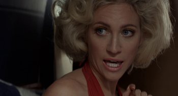 Movie still from “X” (2022), directed by Ti West – A woman with blonde hair and blue eyes; Close Up shot, Over the shoulder angle