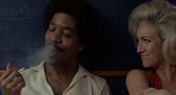 Movie still from “X” (2022), directed by Ti West – A man smoking a cigarette next to a woman; Close Up shot, Over the shoulder angle