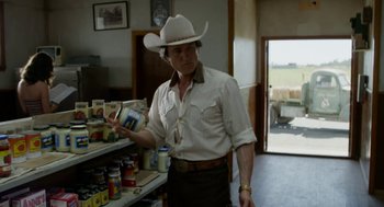 Movie still from “X” (2022), directed by Ti West – A man wearing a cowboy hat in a grocery store; Medium shot, Over the shoulder angle