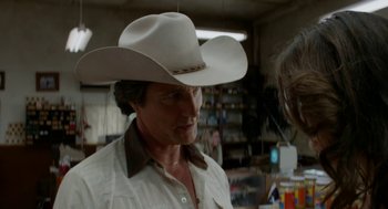 Movie still from “X” (2022), directed by Ti West – A man wearing a white cowboy hat in a room; Close Up shot, Over the shoulder angle