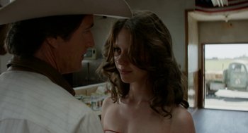 Movie still from “X” (2022), directed by Ti West – A man and a woman standing next to each other in a room; Close Up shot, Over the shoulder angle
