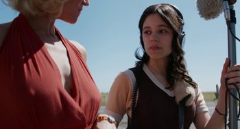 Movie still from “X” (2022), directed by Ti West – Two women standing next to each other on a sunny day; Close Up shot, Over the shoulder angle