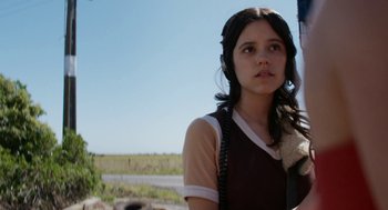 Movie still from “X” (2022), directed by Ti West – A woman with a phone in her hand; Close Up shot, Low angle