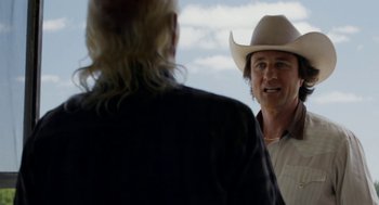 Movie still from “X” (2022), directed by Ti West – A man wearing a cowboy hat talking to another man; Close Up shot, Over the shoulder angle
