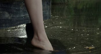 Movie still from “X” (2022), directed by Ti West – A woman's bare feet in a body of water; Extreme Close Up shot, High angle