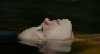 Movie still from “X” (2022), directed by Ti West – A woman floating in a body of water; Extreme Close Up shot, Overhead angle