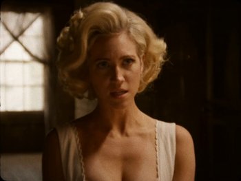 Movie still from “X” (2022), directed by Ti West – A woman in a white dress with blonde hair; Close Up shot, Over the shoulder angle
