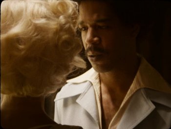 Movie still from “X” (2022), directed by Ti West – A person with a hair brush; Close Up shot, Over the shoulder angle