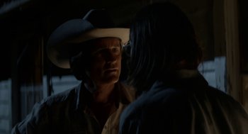 Movie still from “X” (2022), directed by Ti West – A man and a woman in a dark room; Close Up shot, Over the shoulder angle